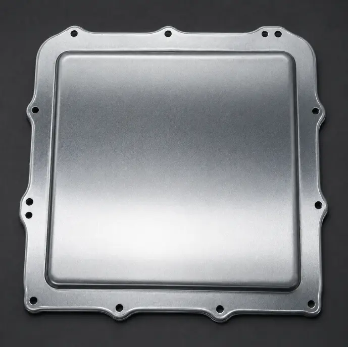 Stamped metal housing cover with formed edges and mounting holes